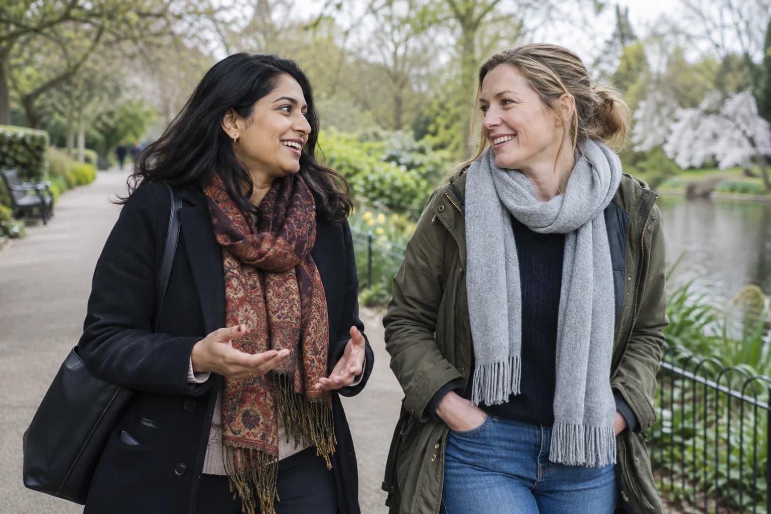 Two women talking together during a park walk